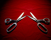 Left and right handed scissors on red fabri