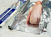 Aluminium foil wrapping chicken