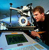 Technician performing X-ray stress test on a cog