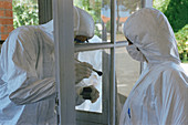 Forensics officers dusting for prints