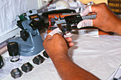 Technician using digital vernier calipers