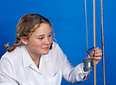 Schoolgirl investigating elasticity