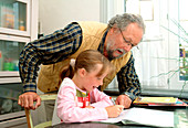 Grandfather helping his grandaughter