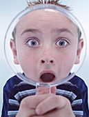 Boy using magnifying glass