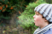 Boy's breath condensing in cold air