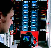 Technician studies circuits using thermograph