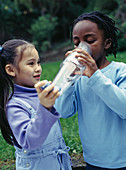 Children using asthma inhaler