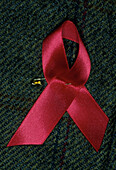 Red ribbon on lapel,symbol of AIDS awareness