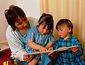 Girl with Down's syndrome with mum and sister