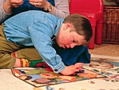 7-year-old boy with Down's syndrome playing a game