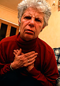 Elderly woman having angina attack