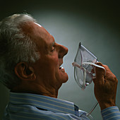 Elderly man using oxygen mask after heart attack