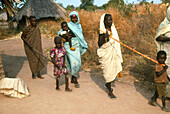 Children leading women blinded by onchocerciasis