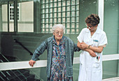 Elderly woman with Parkinson's disease,and nurse