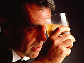 Depressed man holding a drink