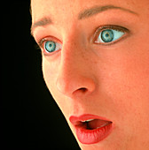 Close-up of a woman's face showing fear/alarm