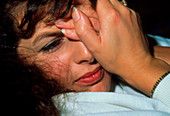Depressed woman with hands held to her face