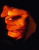 Abstract image of a face on a man's clenched fist