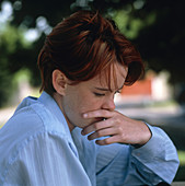Depressed teenage girl looking unhappy outdoors