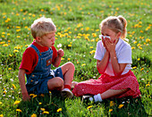 Young girl in meadow sneezing