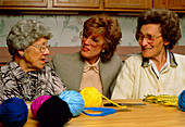 Old-age care: elderly women occupied with knitting