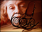Aging: elderly woman's face and a rocking chair