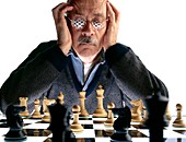 Elderly man plays a game of chess