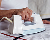 Elderly woman ironing