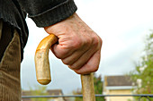 Elderly man holding a walking stick