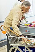 Elderly man at a check-out