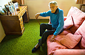 Elderly man sitting on a sofa