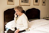 Elderly woman using a telephone