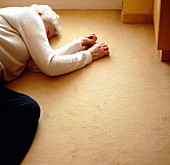 Elderly woman lying on the floor