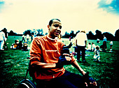 Man in wheelchair drinking