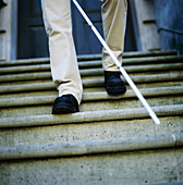 Blind man descending stairs