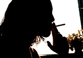 Silhouette of woman smoking a cigarette