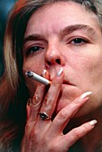 Face of a woman smoking a cigarette