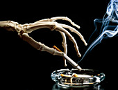 Hand of skeleton holding a cigarette
