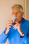 Elderly man smoking a pipe