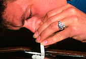 Man snorting a line of cocaine