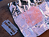 Amphetamine (speed) powdered drug with a razor