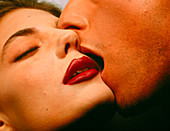 Close-up of a man passionately kissing a woman