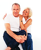 Happy elderly couple sitting together