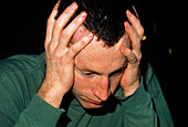 Young man suffering a headache or migraine