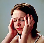 Young woman suffering a headache or migraine