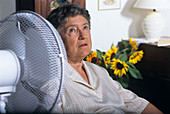 Elderly woman cooling herself