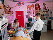 Young girl undergoing an abdominal ultrasound scan