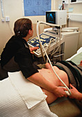 Woman undergoing an abdominal ultrasound scan