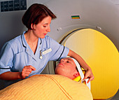 Radiologist prepares patient for a CT brain scan