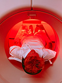 Female patient undergoing an upper-body CT scan